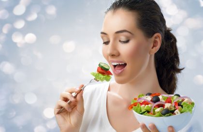 Woman eating a forkful of healthy salad
