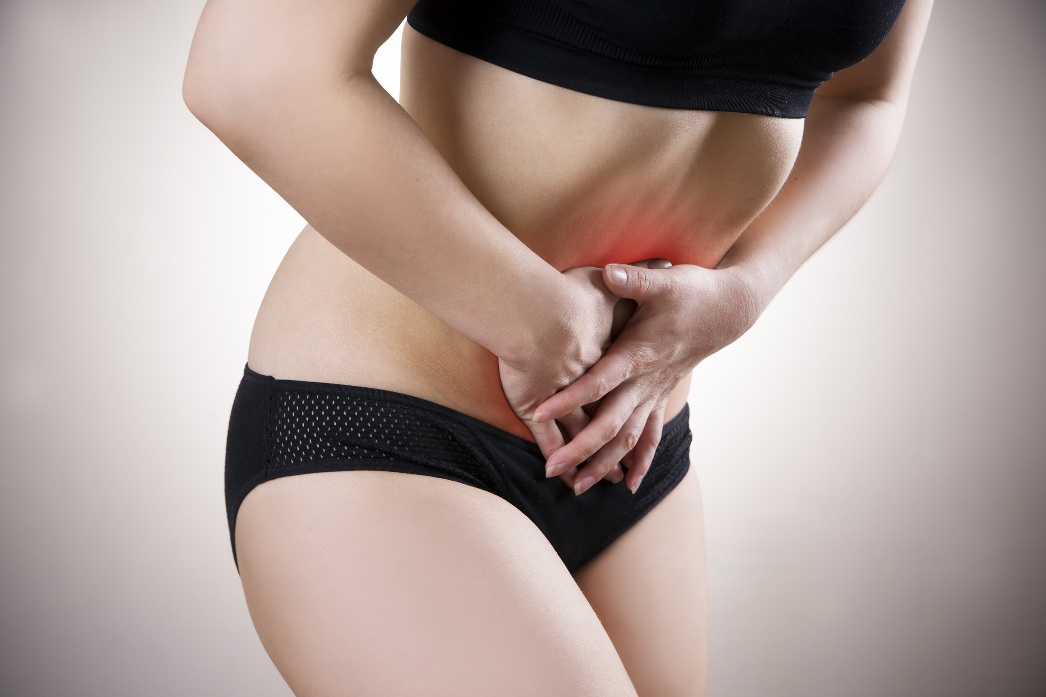 Women clutching stomach with period pain