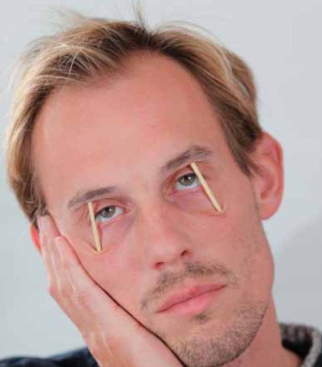 Man With toothpicks holding eyes open
