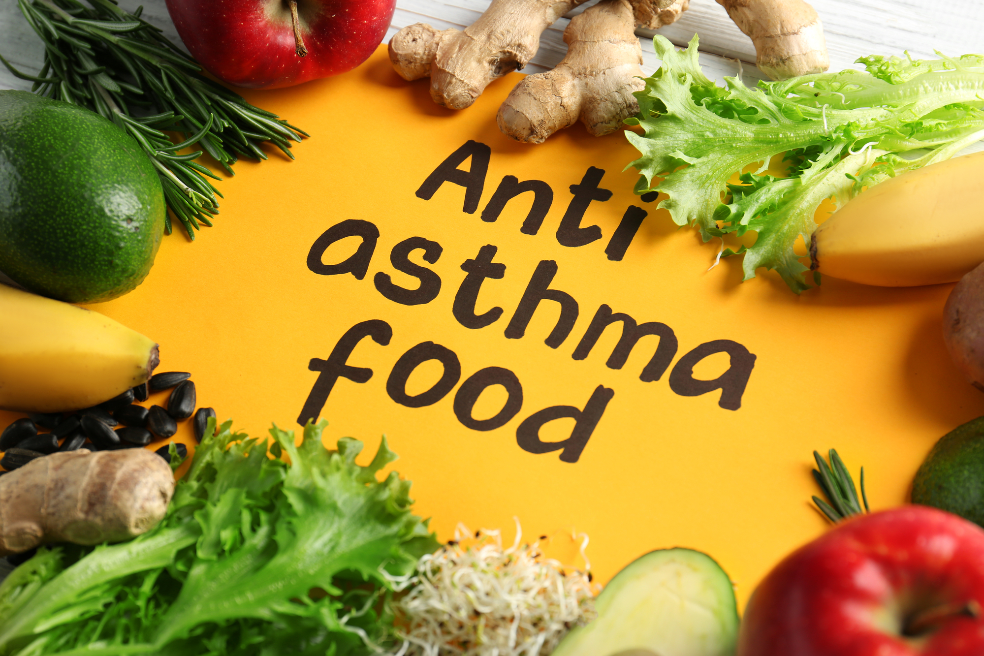 Fresh vegetables and fruits around text ANTI ASTHMA FOOD, close up